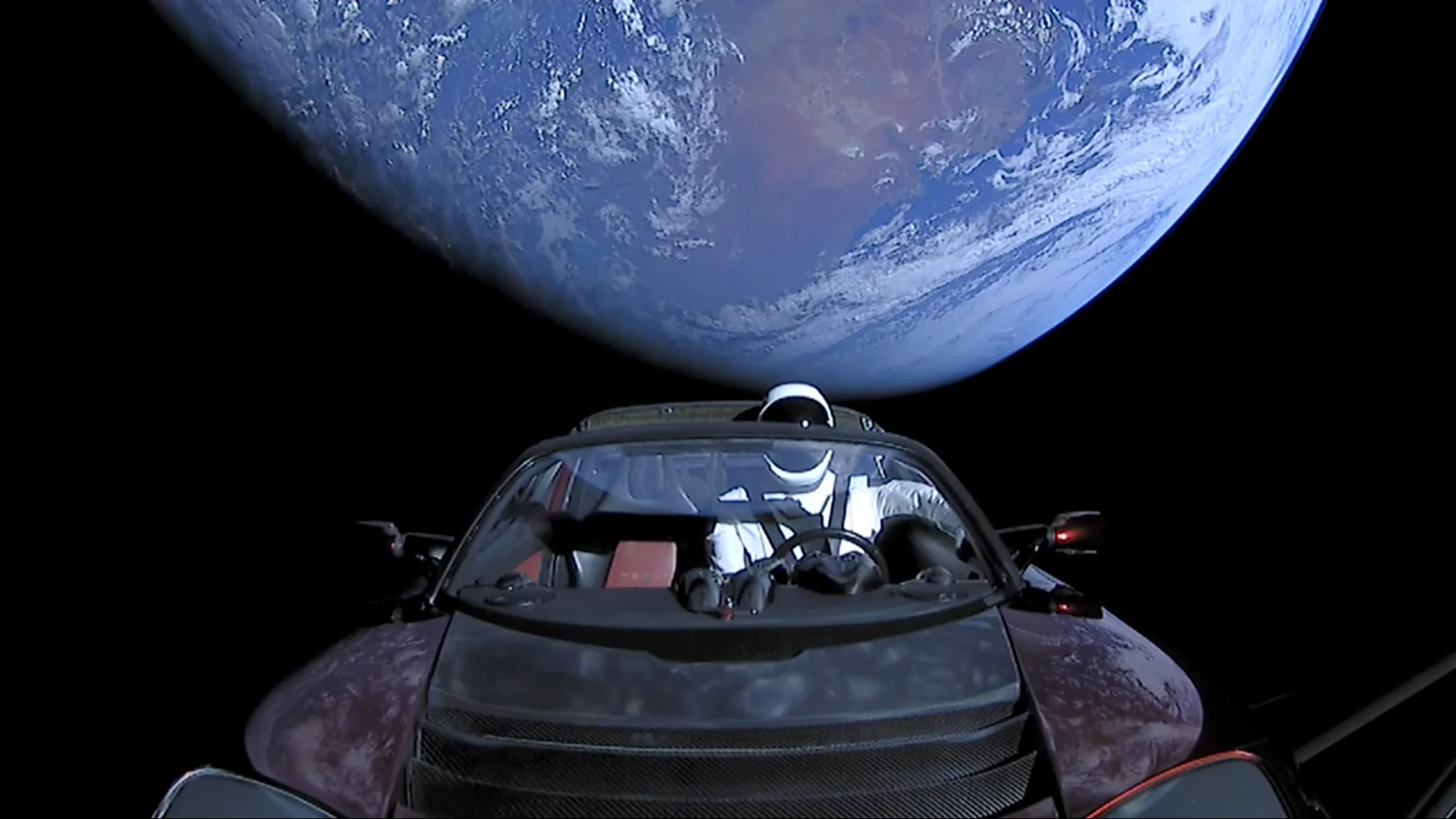 SpaceX mission photograph of the first-generation Roadster, Starman and Earth during the Falcon Heavy demonstration flight on February 6, 2018
